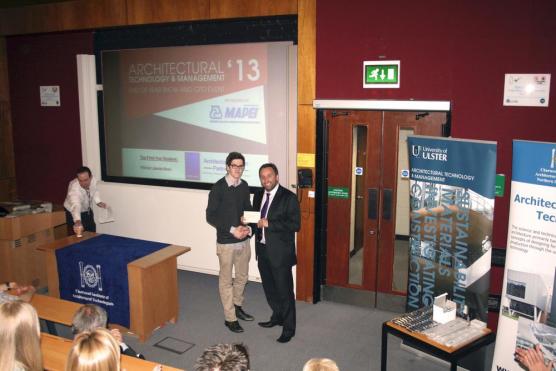 Eddie Weir presents award to student of the university of ulster